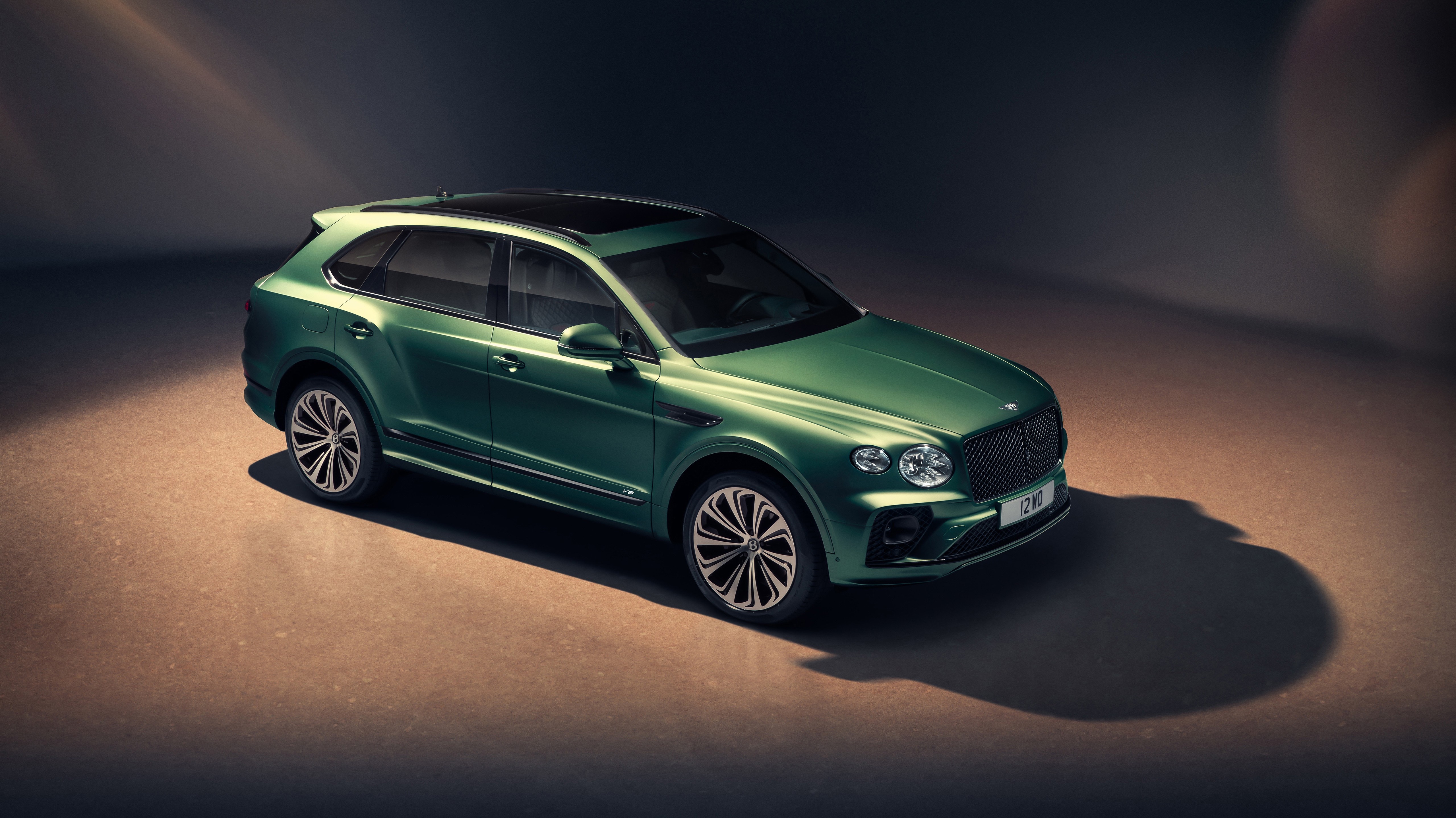 Green 2020 Bentley Bentayga SUV shown from a high-angle front-three-quarter perspective in a studio environment.