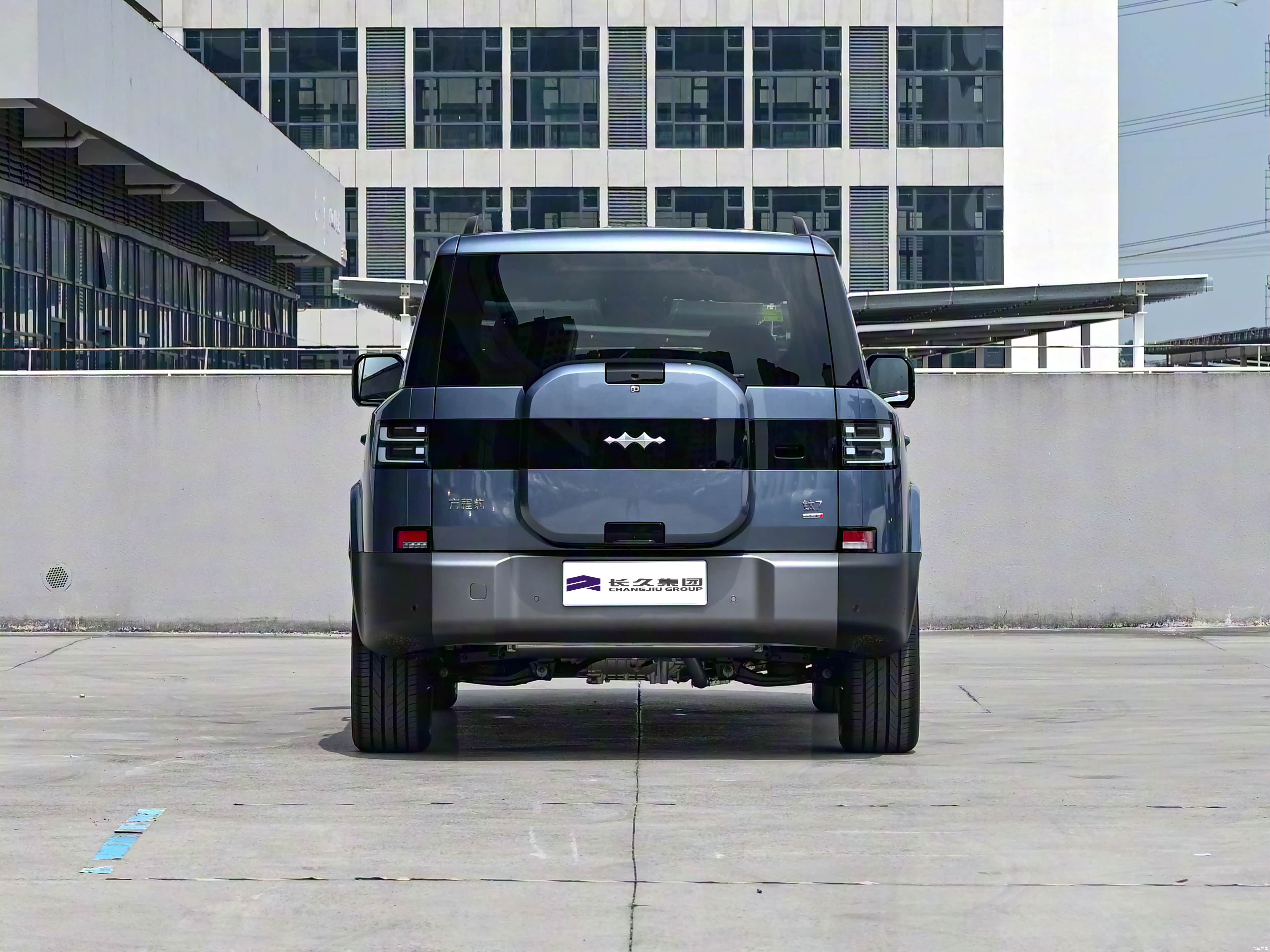 Grey 2025 BYD Leopard 7 SUV shown from the rear with a rear-mounted spare wheel cover outdoors.